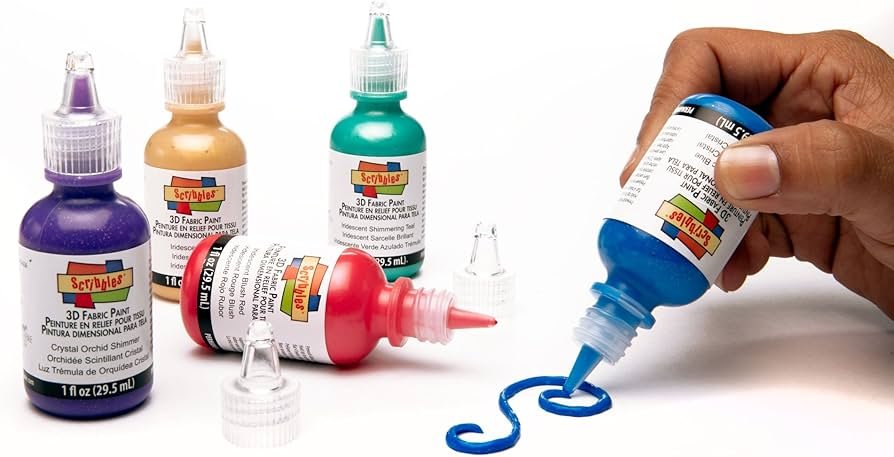 Colorful Joann fabric paint bottles and supplies for decorating textile projects